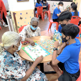 Students playing games with seniors at nursing home